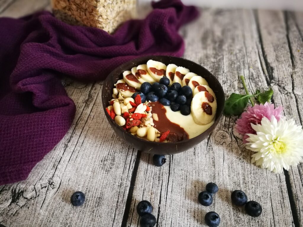 blueberries and nuts with brown syrup in brown bowl